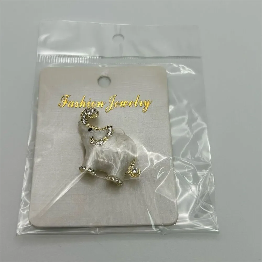 Small Dainty White Elephant Brooch Pin Rhinestone Accents Gold Tone Trunk Up